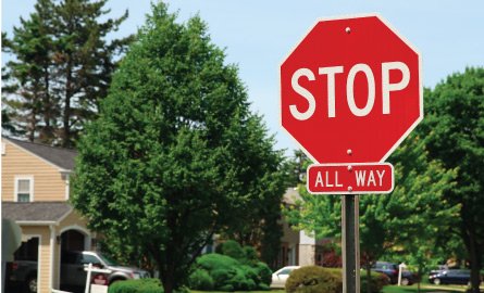 Stop sign at a neighbourhood intersection.